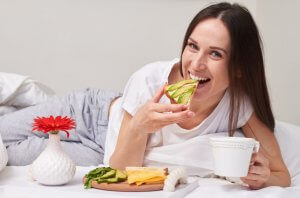 Woman eating healthy foods at home.