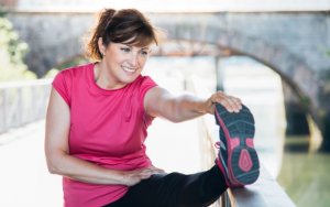 Psychological benefits of exercising, woman stretching.