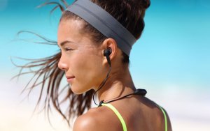 Woman using headphones to enhance her sports performance.