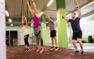 Group of people doing burpees as part of a CrossFit training routine