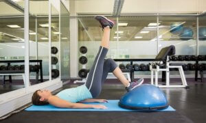 Girl doing leg elevations on a ball