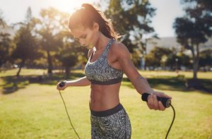 Warm up exercises: woman jumping rope.
