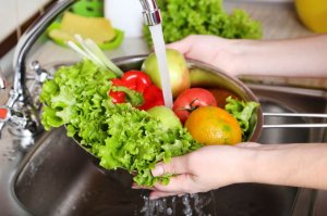Person washing vegetables
