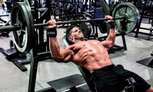 Man doing bench press essential exercises for starting at the gym