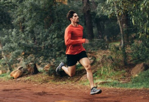 Man in red shirt trail running