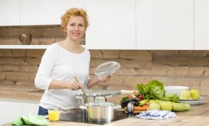 Benefits of eating light food, woman cooking.