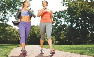 Women walking in the park to reduce stress.