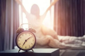 Best routines: woman waking up early.