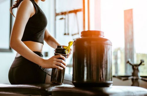 Woman at gym next to supplement jar