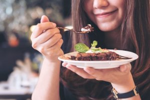 Woman eating protein brownie