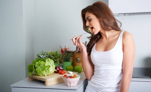 Woman eating salad with ingredients