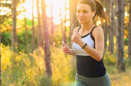 Woman with earbuds running for health