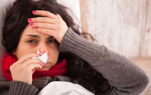 Woman in sweater sick with tissue