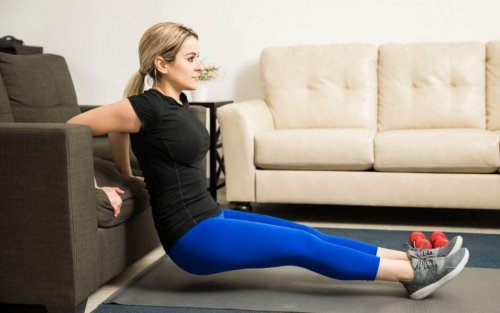 Woman using couch to do presses to exercise arms