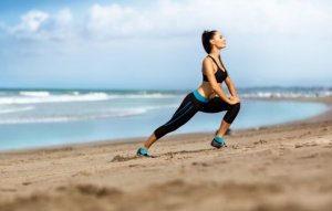 Woman stretching on the beach.