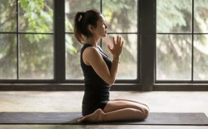Woman doing Yoga indoors.