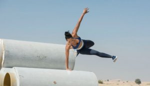 Woman doing an urban sport like Parkour