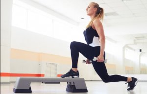A woman doing lunges with weights