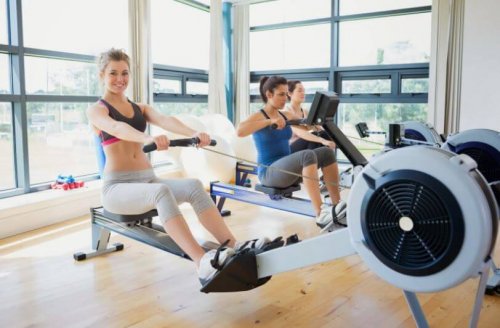 Three women in a gym using rowing machines with good technique