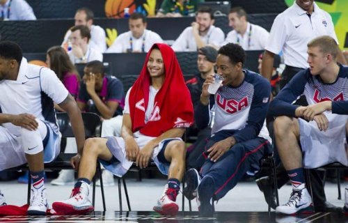 Stephen Curry sitting on a chair.