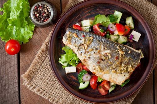 Grilled fish on bed of lettuce