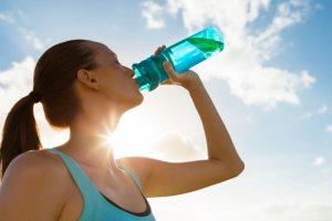 Woman drinking water to avoid dehydration.
