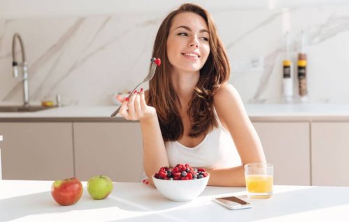 This woman is eating a fruit breakfast.