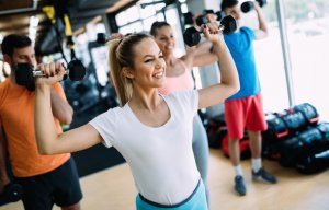 Happy woman working out at the gym
