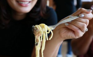 Woman eating pasta