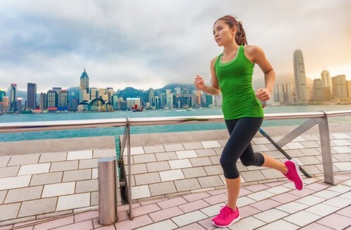 Woman running along boardwalk