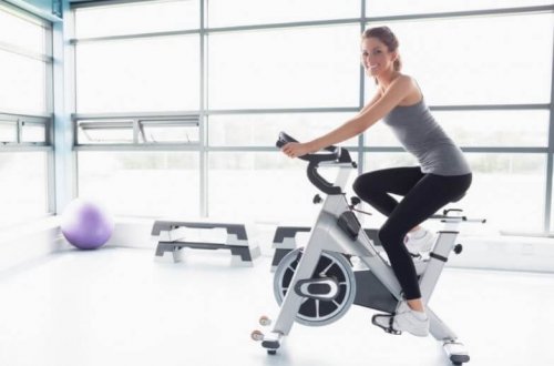 Woman cycling in gym cardio
