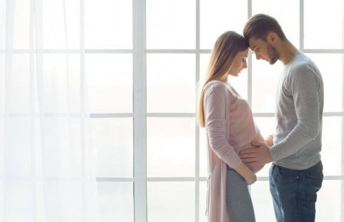 Pregnant woman and her partner stand by window pregorexia