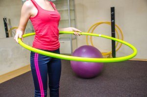 Woman trying to burn fat with hoop.