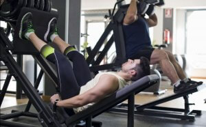 Man working out quadriceps with machine.