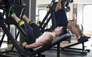 Man working out quadriceps with machine.