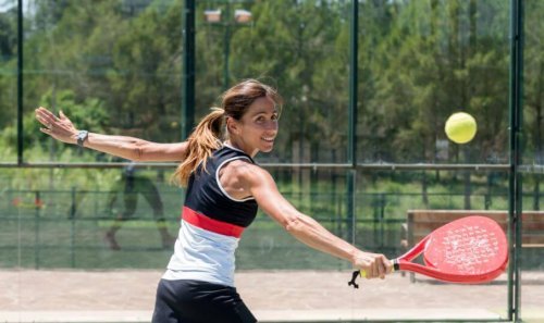 Woman playing paddle tennis outside