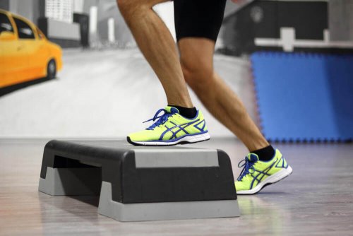 Man doing step-ups in a gym great leg exercises