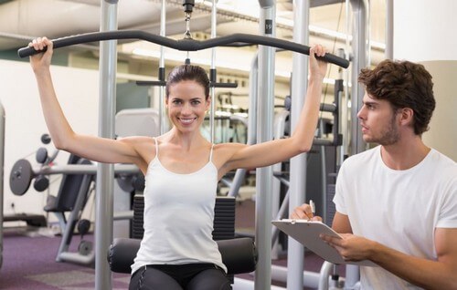 Woman smiling at shoulder press