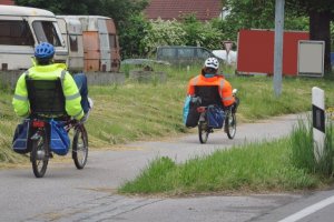 Two people riding recumbent bikes in the countryside