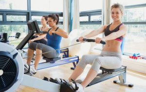 Women using rowing machines at the gym