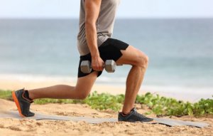 Man doing lunges with dumbbells to get strong legs