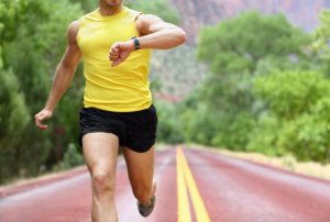 Man using a wrist heart rate monitor while running