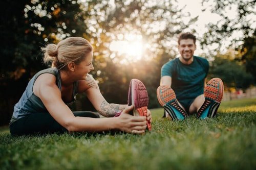 Man and woman stretching in grass