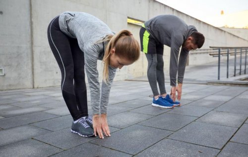Man and woman stretching outside stretches for tight hamstrings