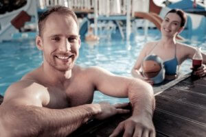 Couple staying healthy and thin during their vacations by swimming