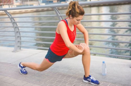Woman next to river stretching lunges prepare your muscles