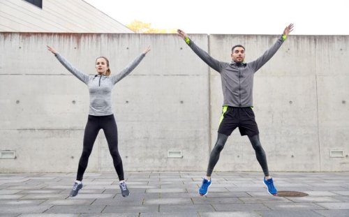 Couple exercising outside jumping tbc session cardio