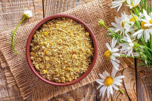 Bowl of dried chamomile herb and flowers