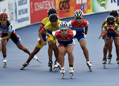 Professional athletes competing in speed skating inline on track
