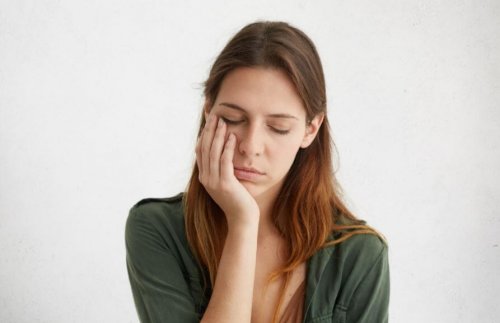 Woman leaning on hand falling asleep exhausted